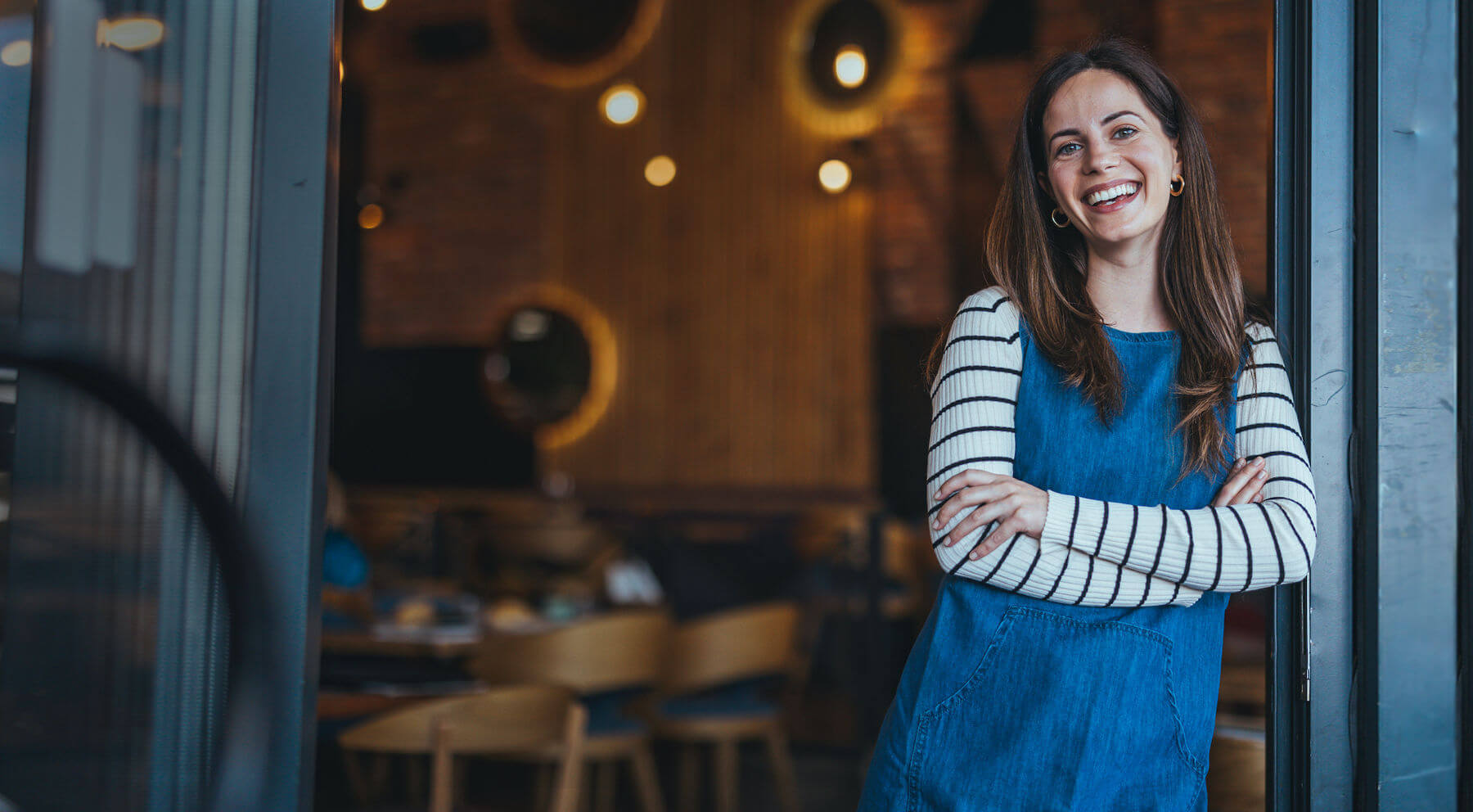 Woman standing in front of her store